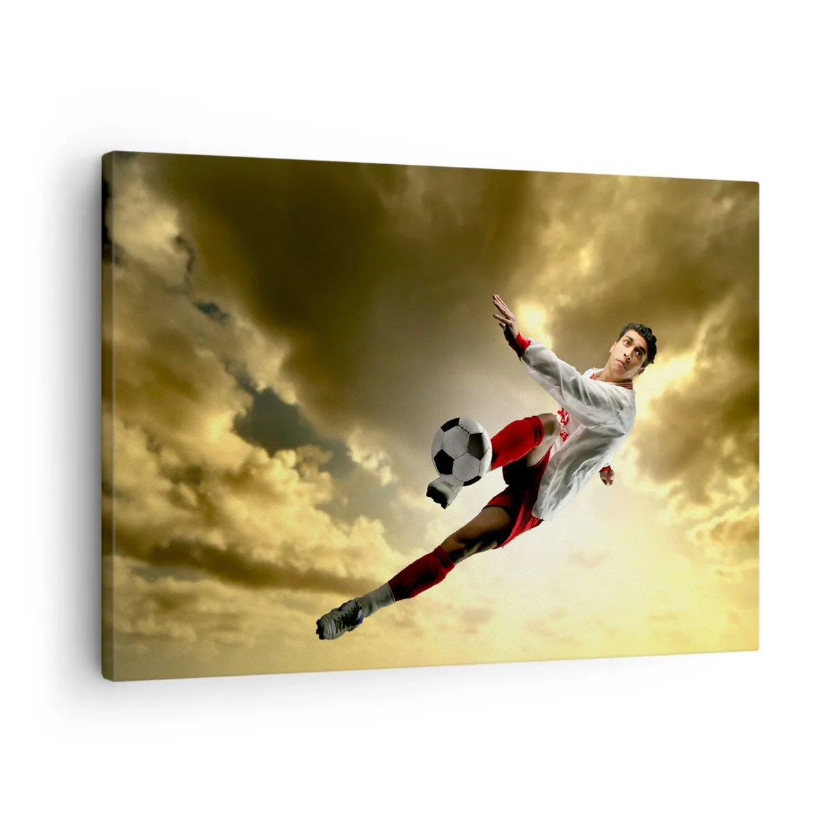 Tablou pe pânză Canvas - Un jucător de fotbal într-o săritură dinamică lovind mingea spre cer - 70x50cm - Cerul fotbalului - Decorațiune modernă pentru perete pentru living și dormitor ARTTOR