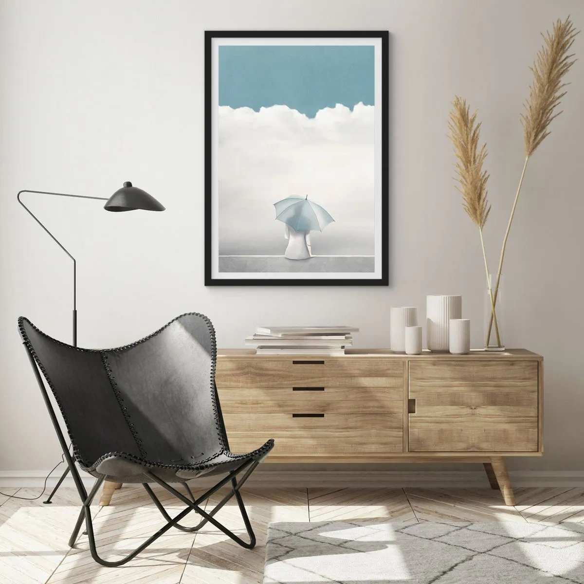 Poster în ramă neagră - O figură cu o umbrelă așezată pe o cornișă printre nori - 50x70cm - La limita dintre realitate și vise - Decorațiune modernă pentru perete pentru living și dormitor ARTTOR