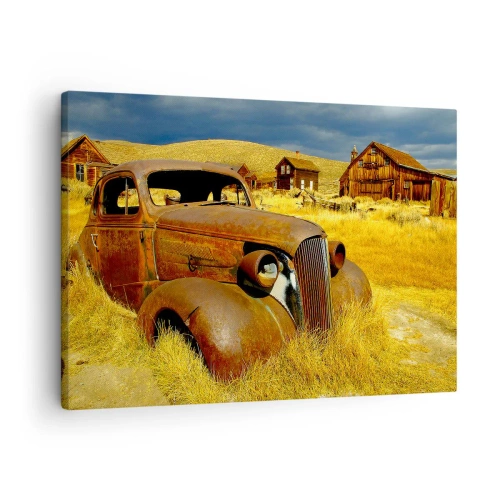 Tablou pe pânză Canvas - O mașină veche și ruginită pe fundalul unor colibele de lemn abandonate - 70x50cm - O odihnă binemeritată - Decorațiune modernă pentru perete pentru living și dormitor ARTTOR