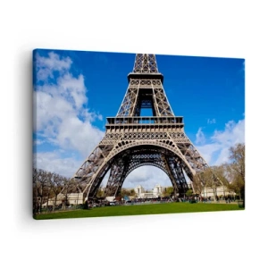 Tablou pe pânză Canvas - Turnul Eiffel pe fundalul unui cer albastru și al unui parc verde - 70x50cm - Întregul Paris la picioarele ei - Decorațiune modernă pentru perete pentru living și dormitor ARTTOR