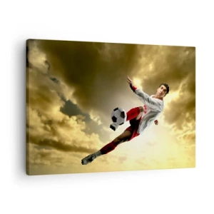 Tablou pe pânză Canvas - Un jucător de fotbal într-o săritură dinamică lovind mingea spre cer - 70x50cm - Cerul fotbalului - Decorațiune modernă pentru perete pentru living și dormitor ARTTOR