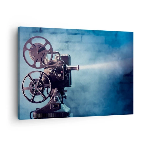 Tablou pe pânză Canvas - Un proiector de film vechi aruncă lumină pe un fundal albastru - 70x50cm - Într-un cinematograf vechi - Decorațiune modernă pentru perete pentru living și dormitor ARTTOR
