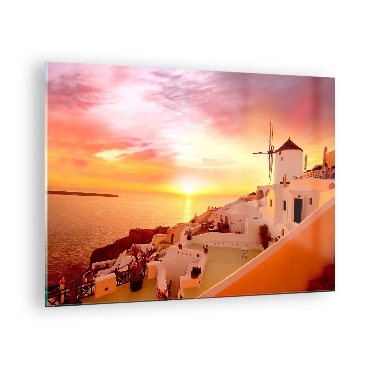 Tablou pe sticlă - Apus de soare peste Santorini cu clădiri albe și o moară de vânt - 70x50cm - Dizolvându-se în alb și auriu - Decorațiune modernă pentru perete pentru living și dormitor ARTTOR